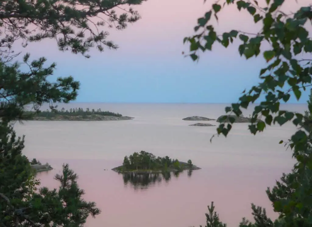 calm body of water under blue sky