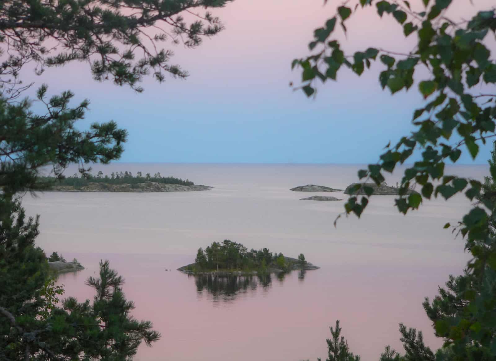 calm body of water under blue sky