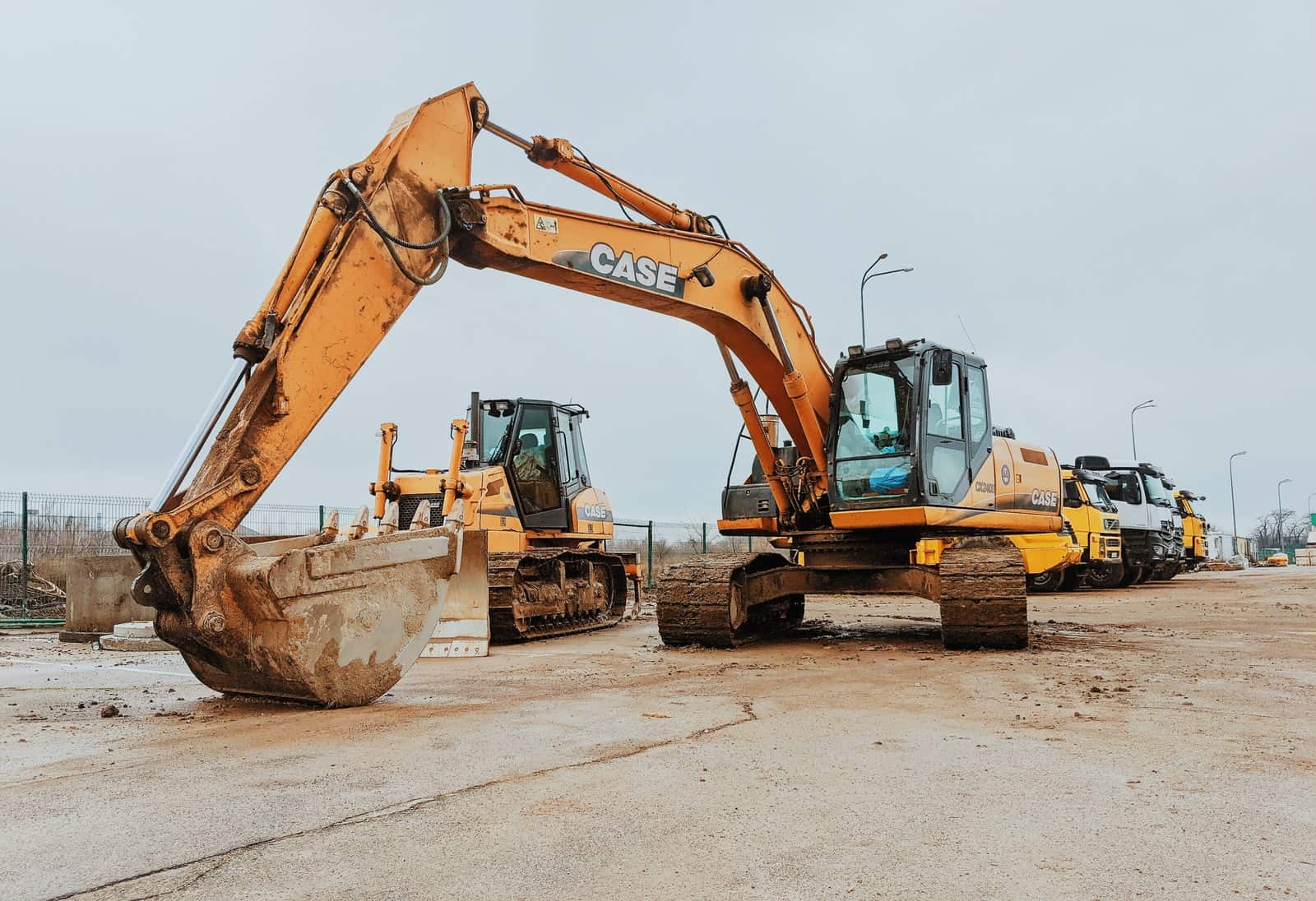 yellow excavator on gray concrete road during daytime