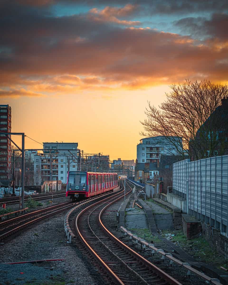 train rail near city buildings during daytime