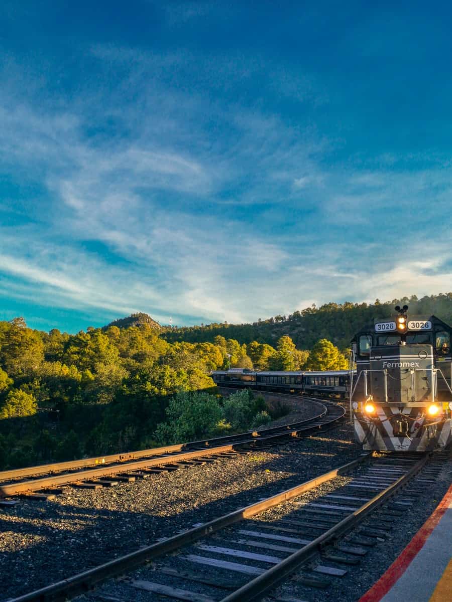 black train with light on during daytime