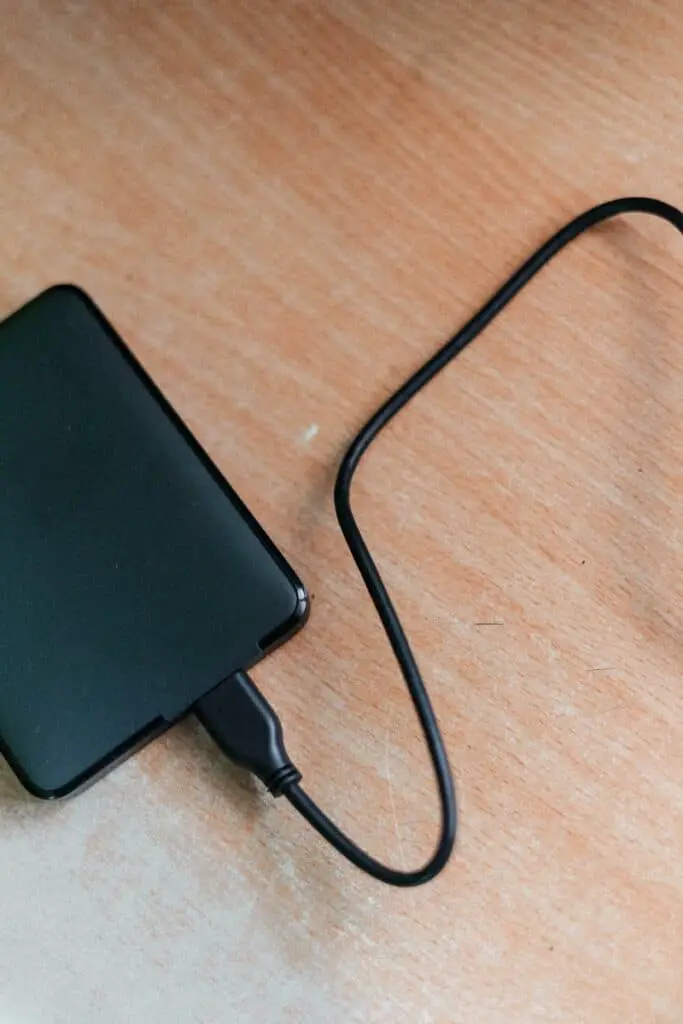 black power bank on brown wooden table