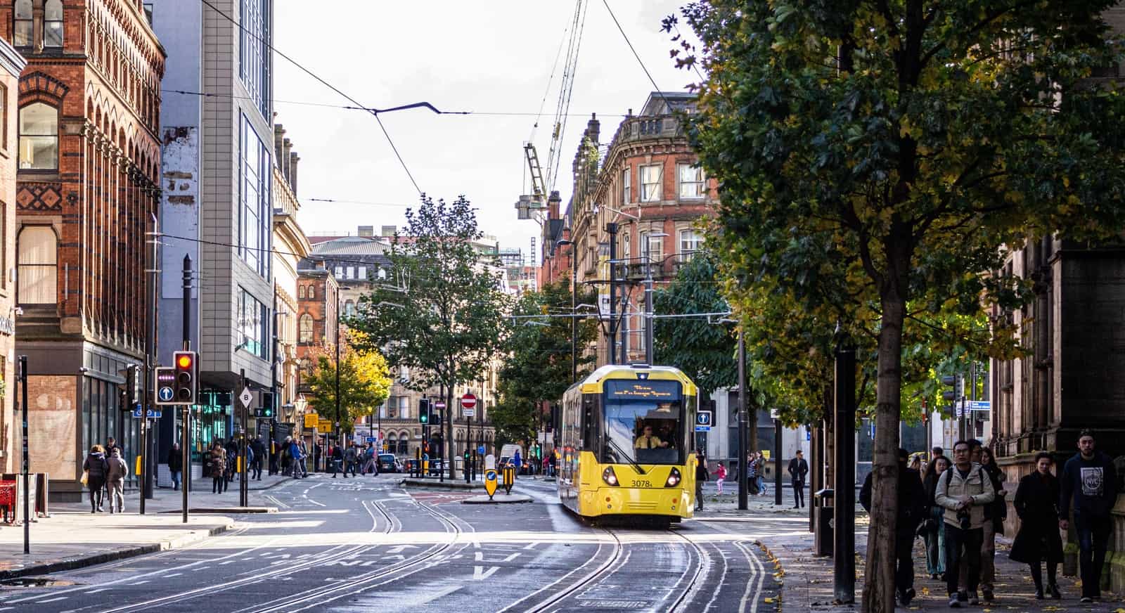 yellow and black tram on road during daytime