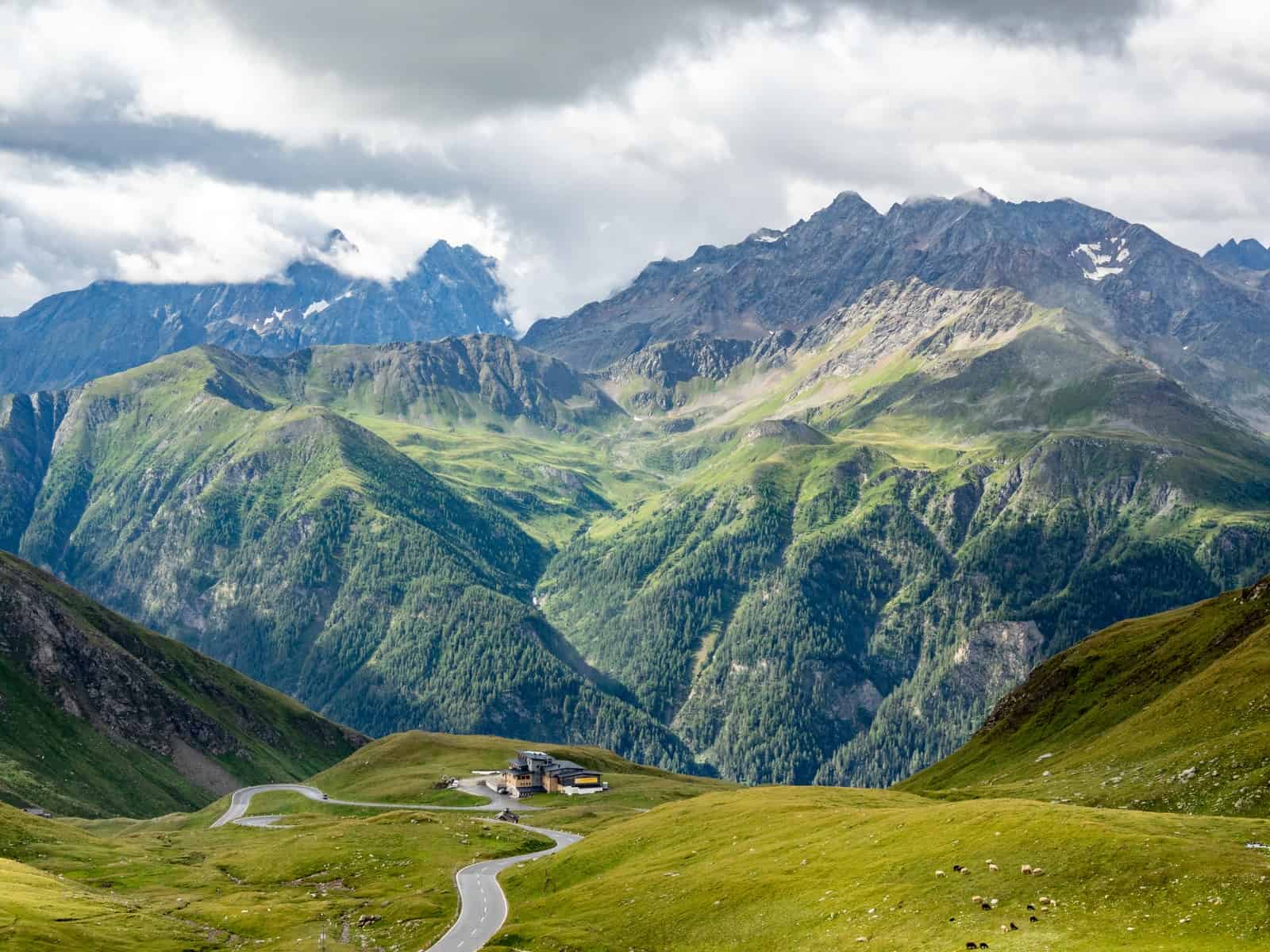 green and white mountains under white clouds during daytime