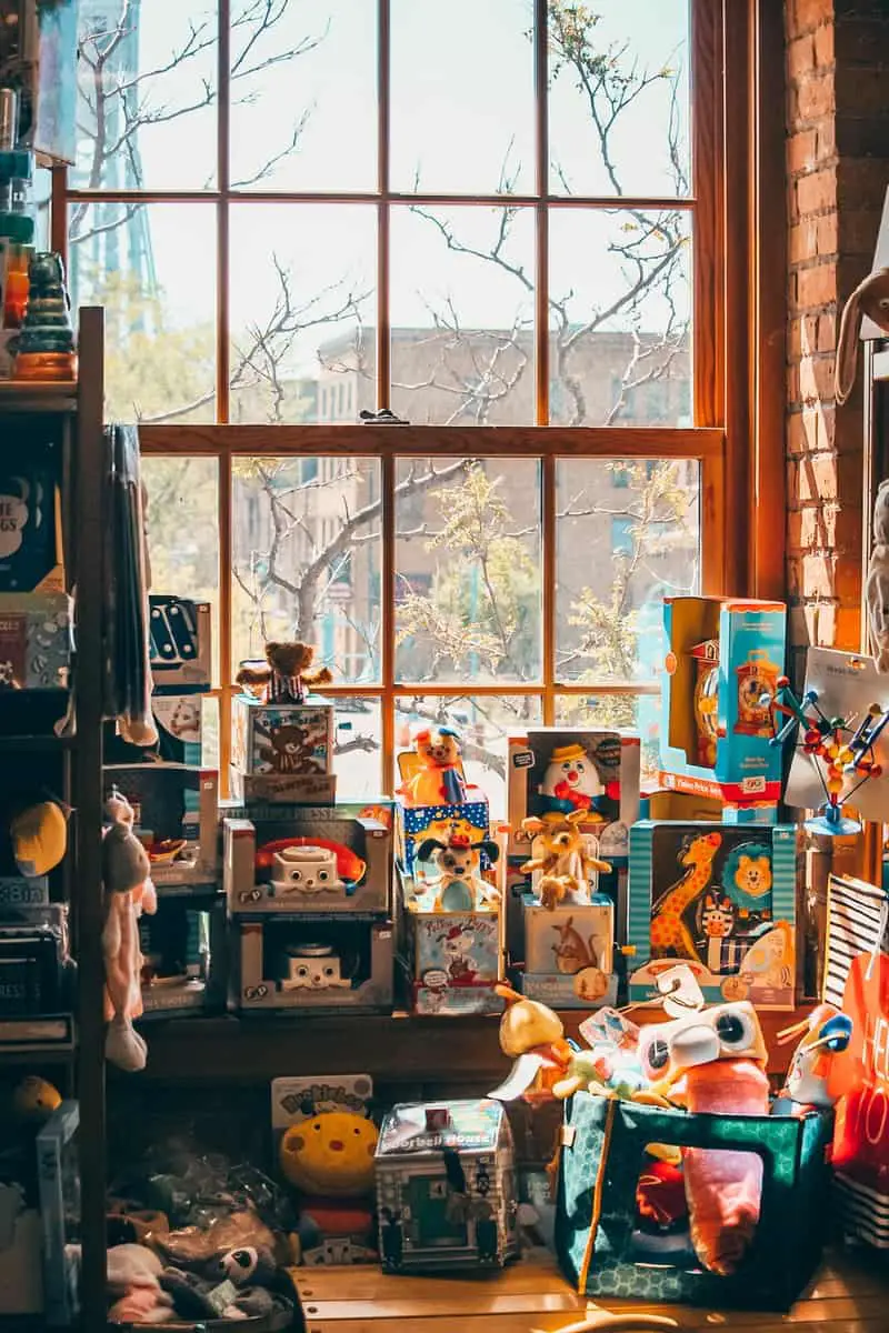 assorted plush toys on brown wooden shelf