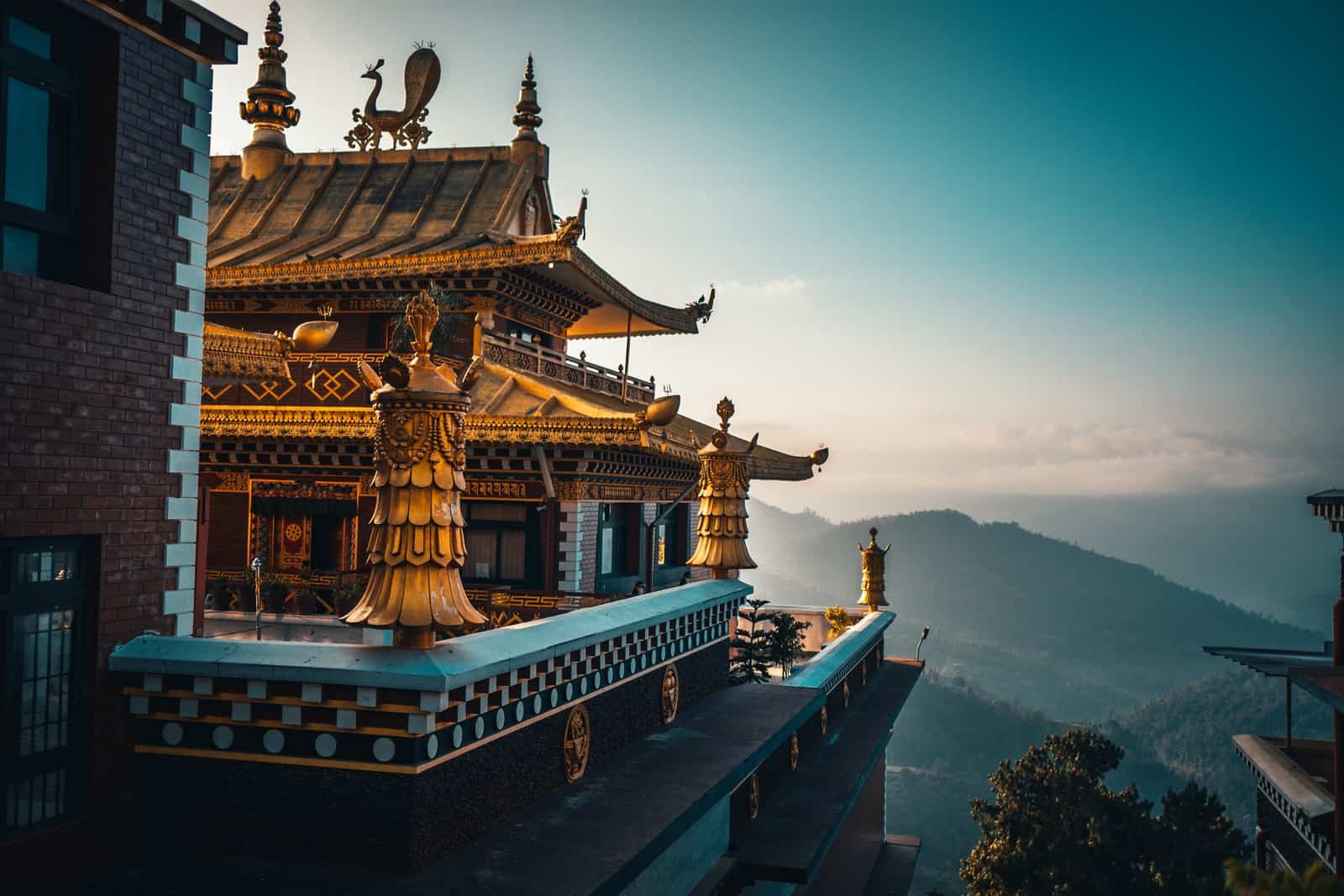 brown and green temple on top of mountain during daytime