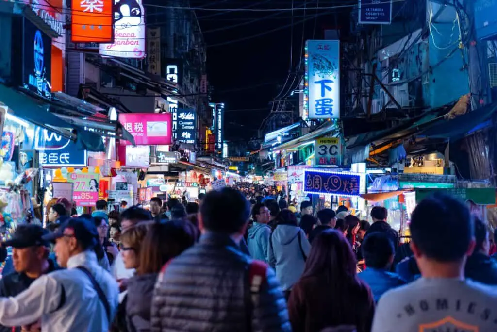 people walking on street during night time