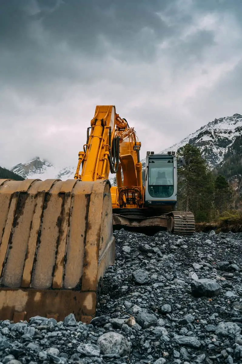 yellow and black heavy equipment on rocky ground