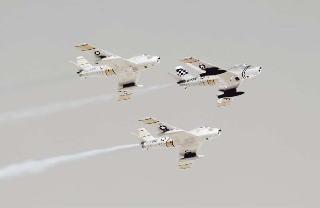 three white-and-black jet planes