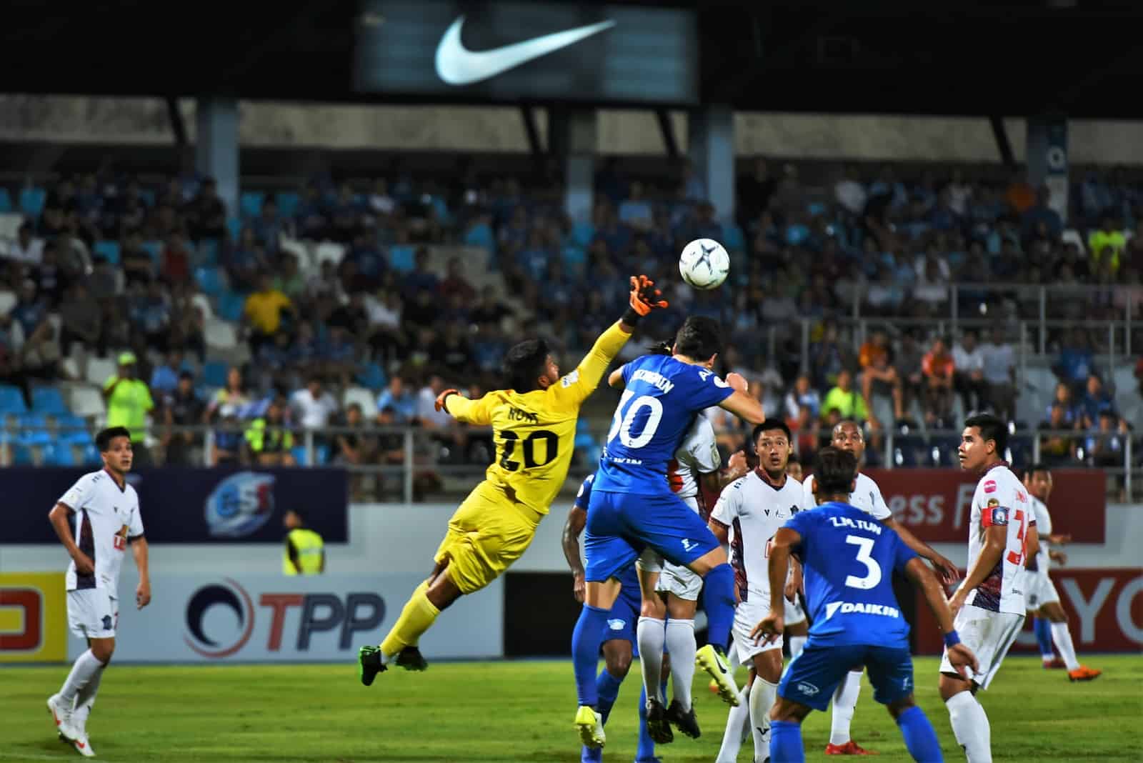 man in blue and yellow jersey shirt playing soccer