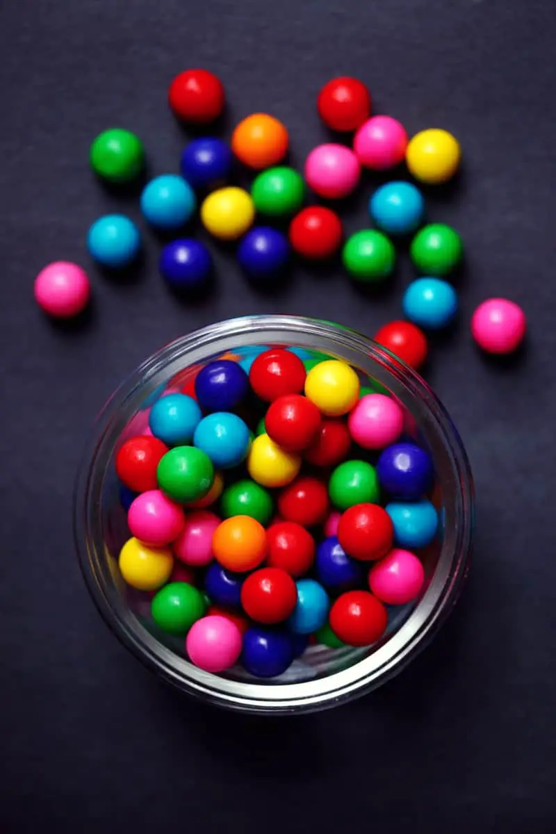 red green blue and yellow m ms candies in clear glass bowl