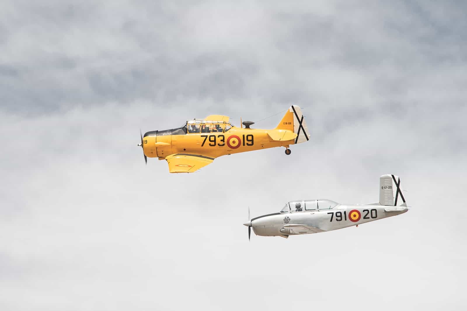 white and yellow jet plane in mid air