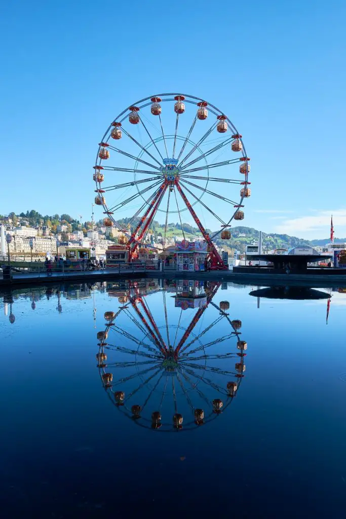 ferris wheel near body of water during daytime