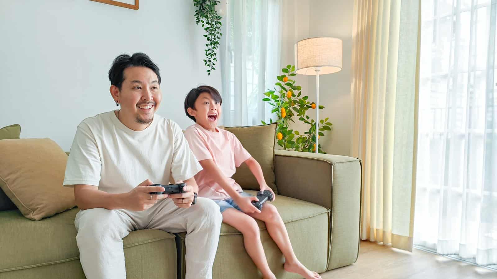 a person and a child sitting on a couch