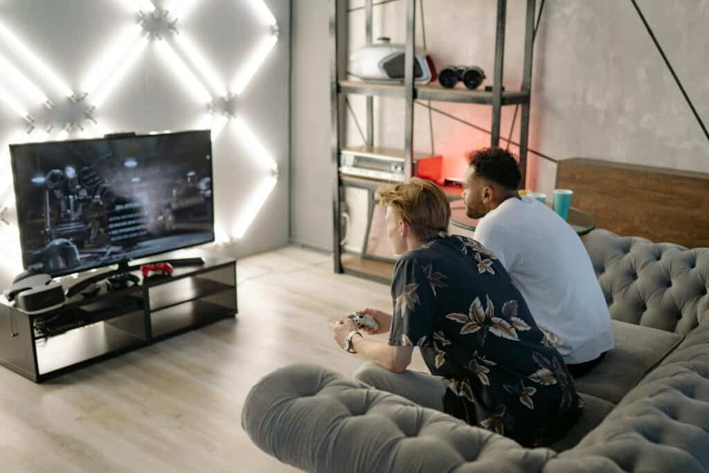 Woman in Black and White Floral Shirt Sitting on Gray Couch