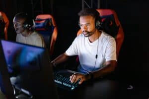 Photo of a Man in a White Shirt Playing on a Computer