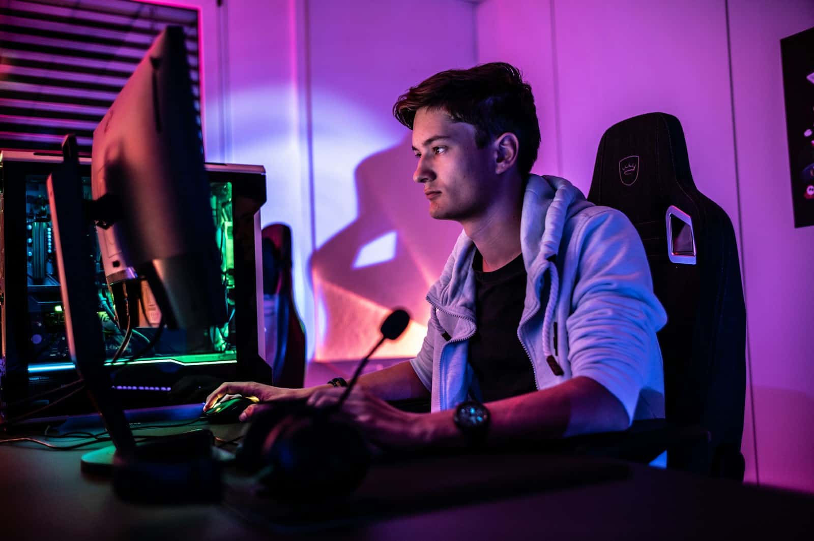 a man sitting in front of a computer monitor