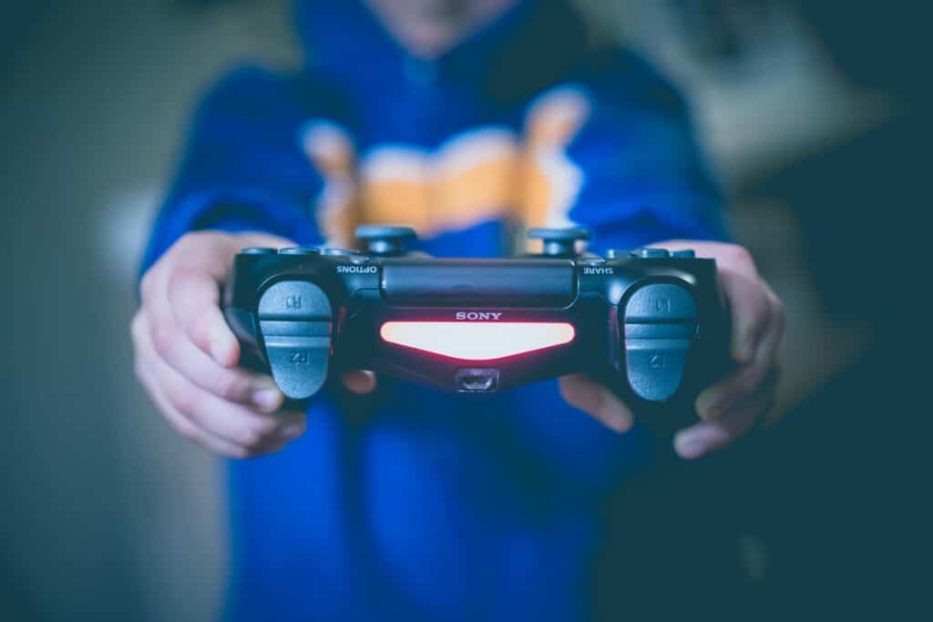 person holding black wireless controller