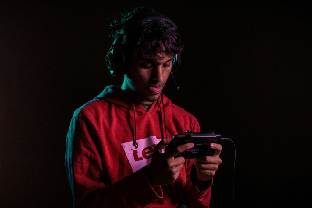 man in red hoodie holding black semi automatic pistol